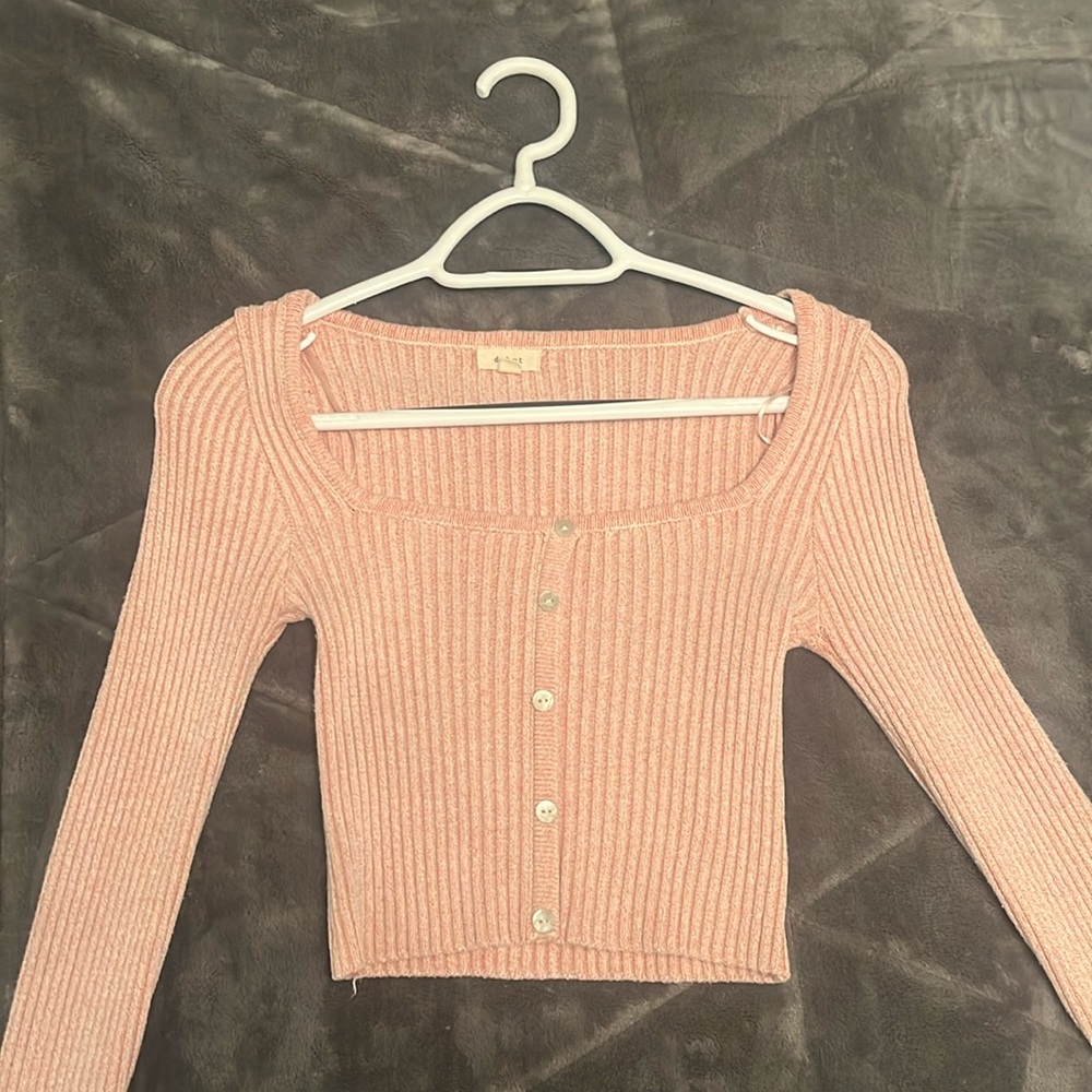 A tight shirt, in a light pink colour.